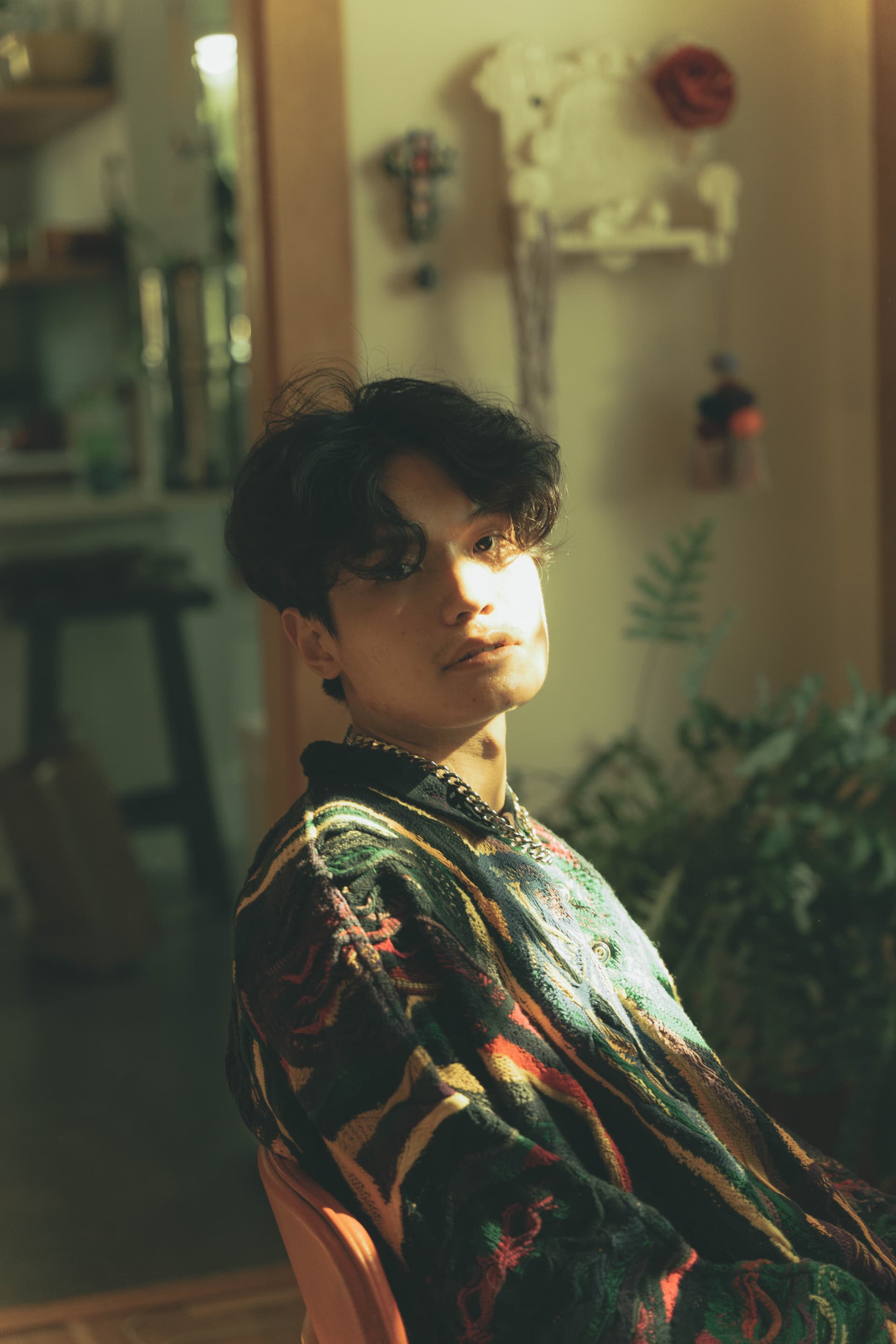 An Hoang in a colorful patterned shirt with warm golden lighting